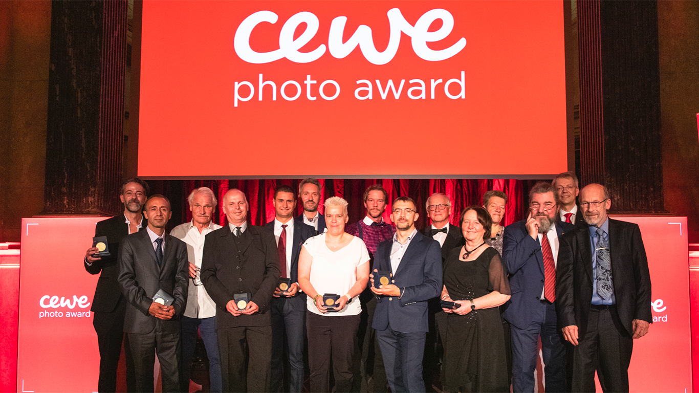 CEWE Photo Award. Autoři vítězných fotografií a porotci na jednom pódiu. září 2019, Vídeň.