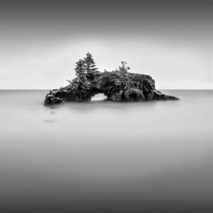 Hollow Rock is an iconic structure located just south of Grand Portage Minnesota on Lake Superior about 10 miles south of the Canada. The star of the show is of course, the rock formation known as Hollow Rock. The unique geologic formation juts out from the shore as Lake Superior continues to splash around and through the craggy hollow. The rock changes with the waves and the weather. In the winter it is dusted with snow or decorated with glistening ice formations. When the sky is calm and the lake a peaceful periwinkle blue, visitors can leapfrog across the rocks to almost enter the hollow. There are few experiences more rewarding or relaxing than making your way to the opening to sit and listen to the “gulg-gulg-gulg” of the waves against the worn cavern walls.