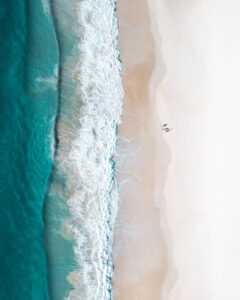 Beautiful beach and water at sunrise with people standing in front of wave and on white sand on the Gold Coast. Queensland New South Wales Brisbane Byron Bay Sunshine Coast Noosa Bondi Manly; Shutterstock ID 1464261053; purchase_order: Buchvorlage; job: ; client: ; other: