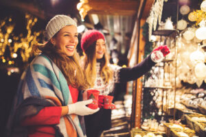 Girl friends having fun and enjoying on Christmas market